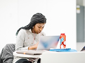 A student works on her laptop 