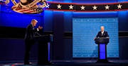 President Trump and Vice-President Biden debate from podiums on a stage 