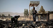 Yemeni police inspect a site of Saudi-led airstrikes