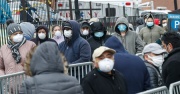 NYC line, people waiting with masks on to be screened 