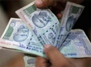 someone holding a handful of INR