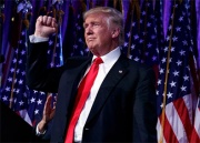 Donald trump holding up his fist on stage after his election victory was announced