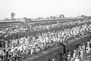 Hundreds of people sitting on and around train in Pakistan