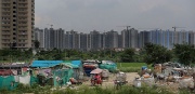 Image of urban high rise behind migrant quarters in South Asia
