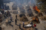 Funeral pyres of victims of COVID-19 burn at a lot that has been converted into a mass crematorium in New Delhi on April 24. 