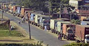 Line of trucks delivery supplies to Nepal from India
